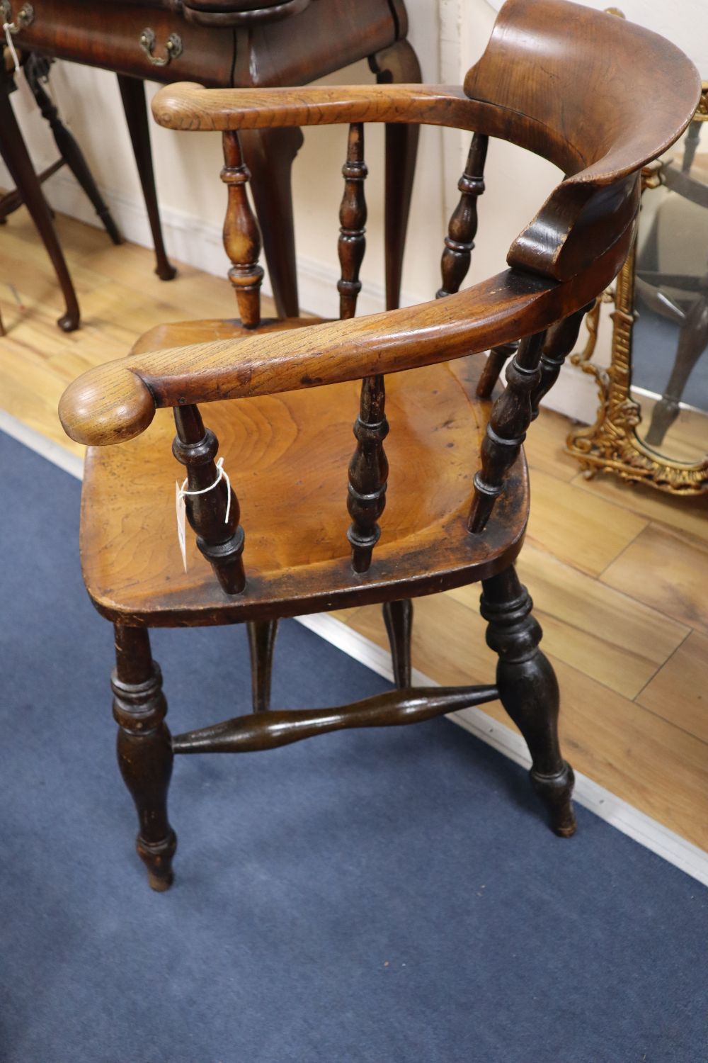 A Victorian ash and elm smokers bow armchair